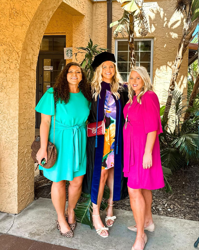 E. Lynn Gibbons and daughter Katelynn Gibbons with Delanie Gibbons at her graduation ceremony